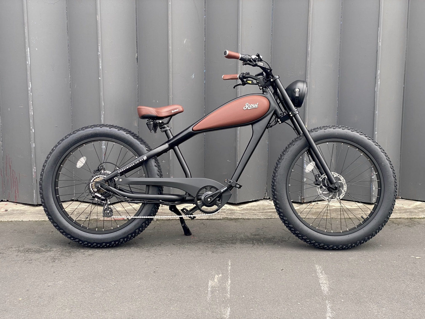 The Scout Electric Motorbike from Boostbikes. Classic Black and Tan detailing, matt black frame with tan vegan leather seat, tank and grips with Kenda All Terrain tyres. Front Suspension available as an option.
